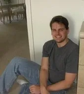 Author Alan Edwards sitting on the floor